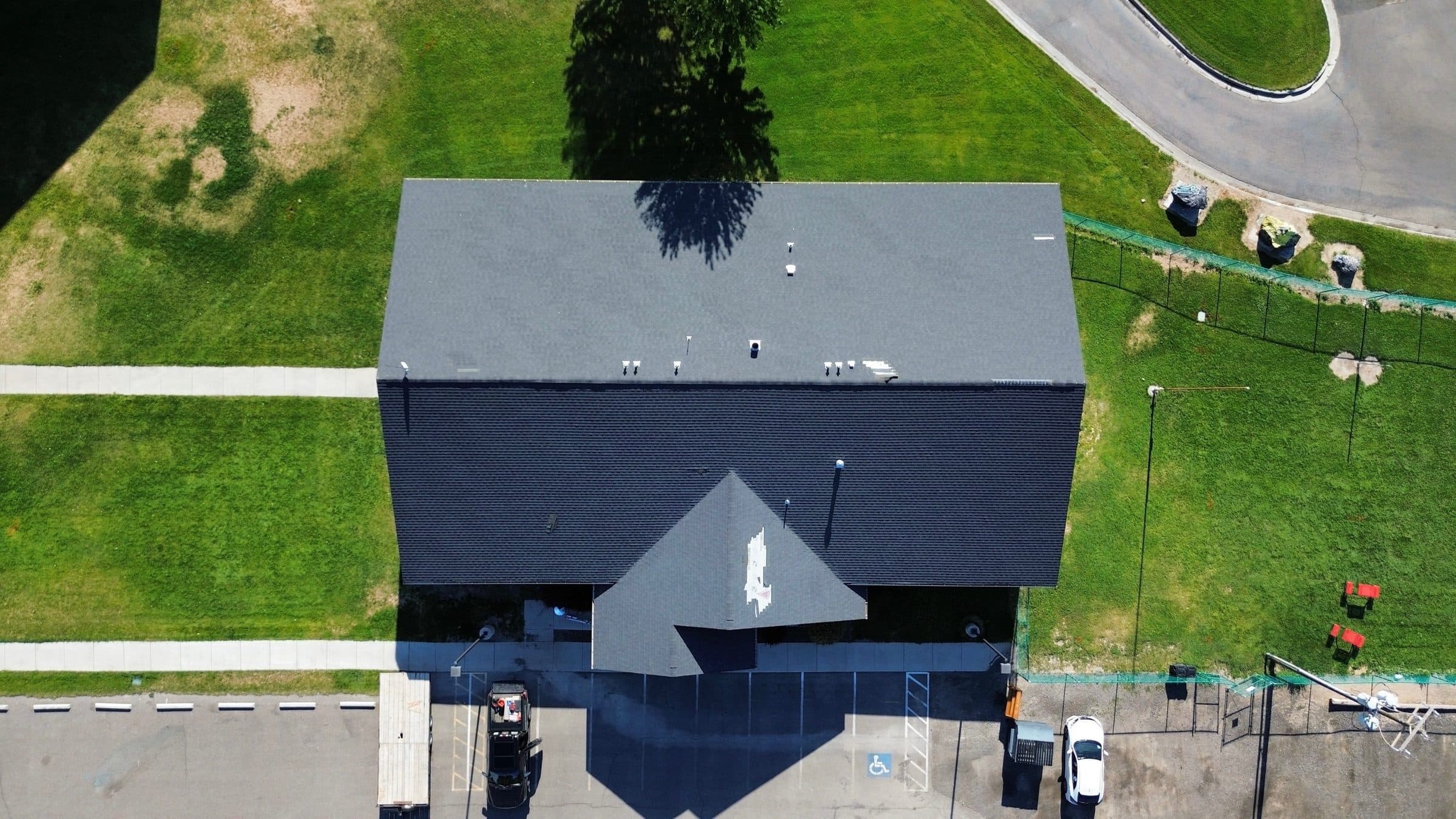 Aerial view of a finished roof with dark shingles